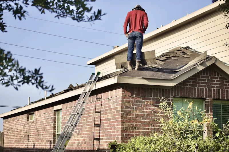Professional roofer working on a residential roof in Lyman